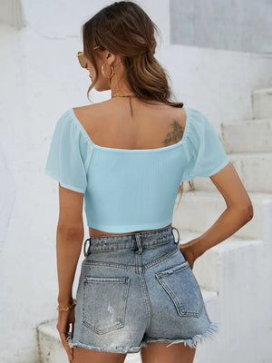 Back view of short sleeve crop top with drawstring waist