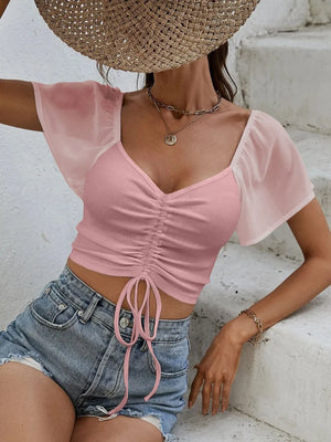 Front view of short sleeve crop top with drawstring waist