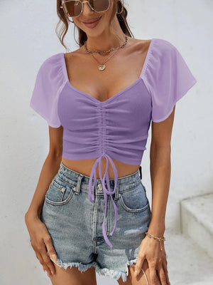 Front view of short sleeve crop top with drawstring waist