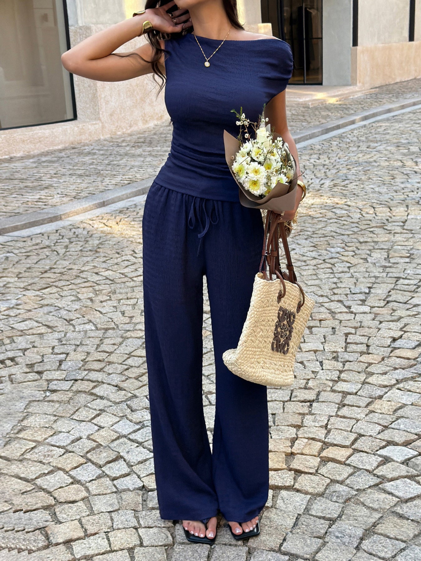Asymmetrical neck top and pants set front view elegant women outfit
