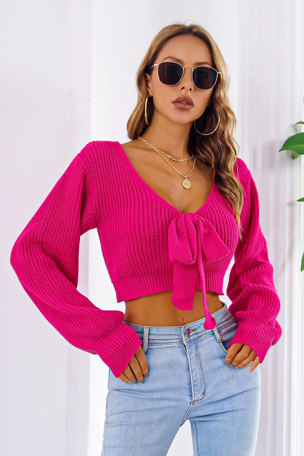 Front view of bow V-neck long sleeve cropped sweater