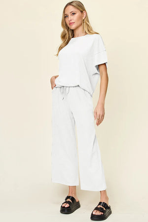Side view of Double Take textured round neck t-shirt and wide leg pants