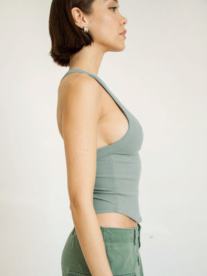 Side perspective highlighting cropped fit and neckline