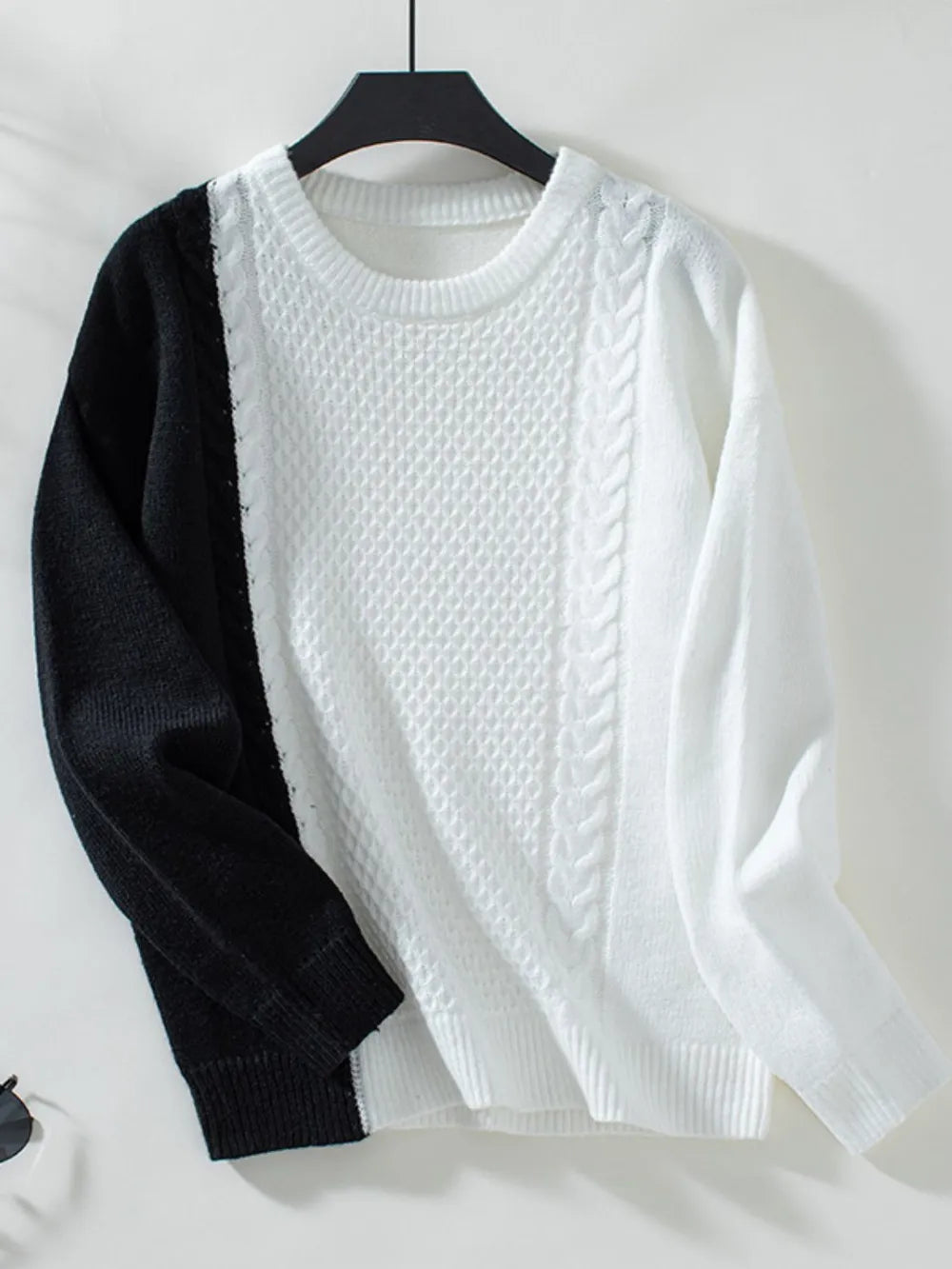 hanging two tone cable knit sweater product display