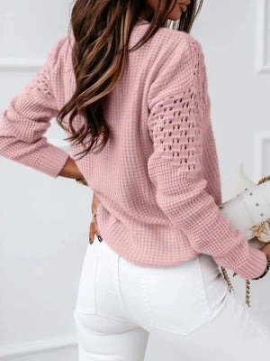 Back view of textured openwork sweater showing detailed knit texture