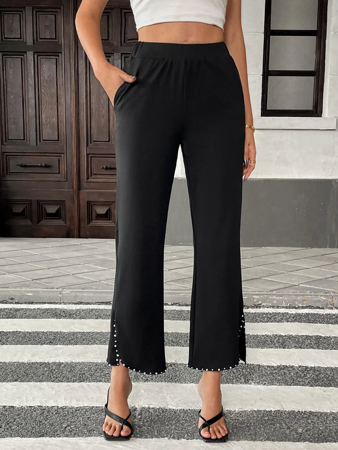 Front view of pearl embellished cropped wide leg pants with high waist design