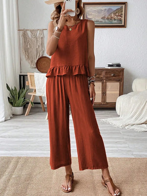 Model wearing ruffled round neck top and wide leg pants front view