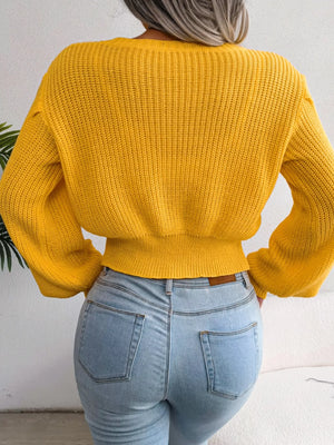 Back view of cable knit round neck cropped sweater