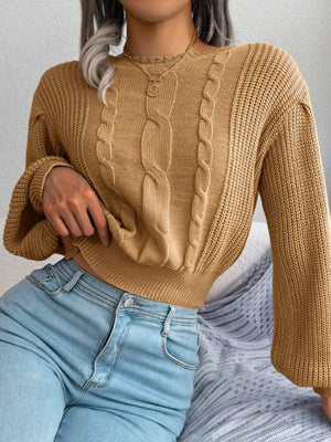 Detail of round neck cable knit sweater