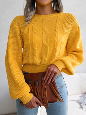 Front view of cropped cable knit sweater