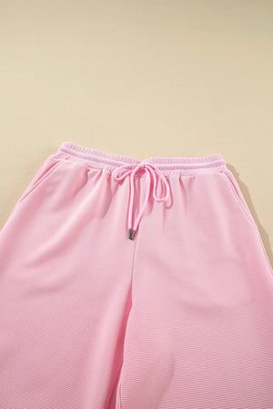 Close up of textured ruffled sleeve top and pants