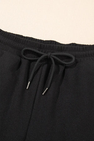 Detailed display of textured ruffled sleeve top and pants set