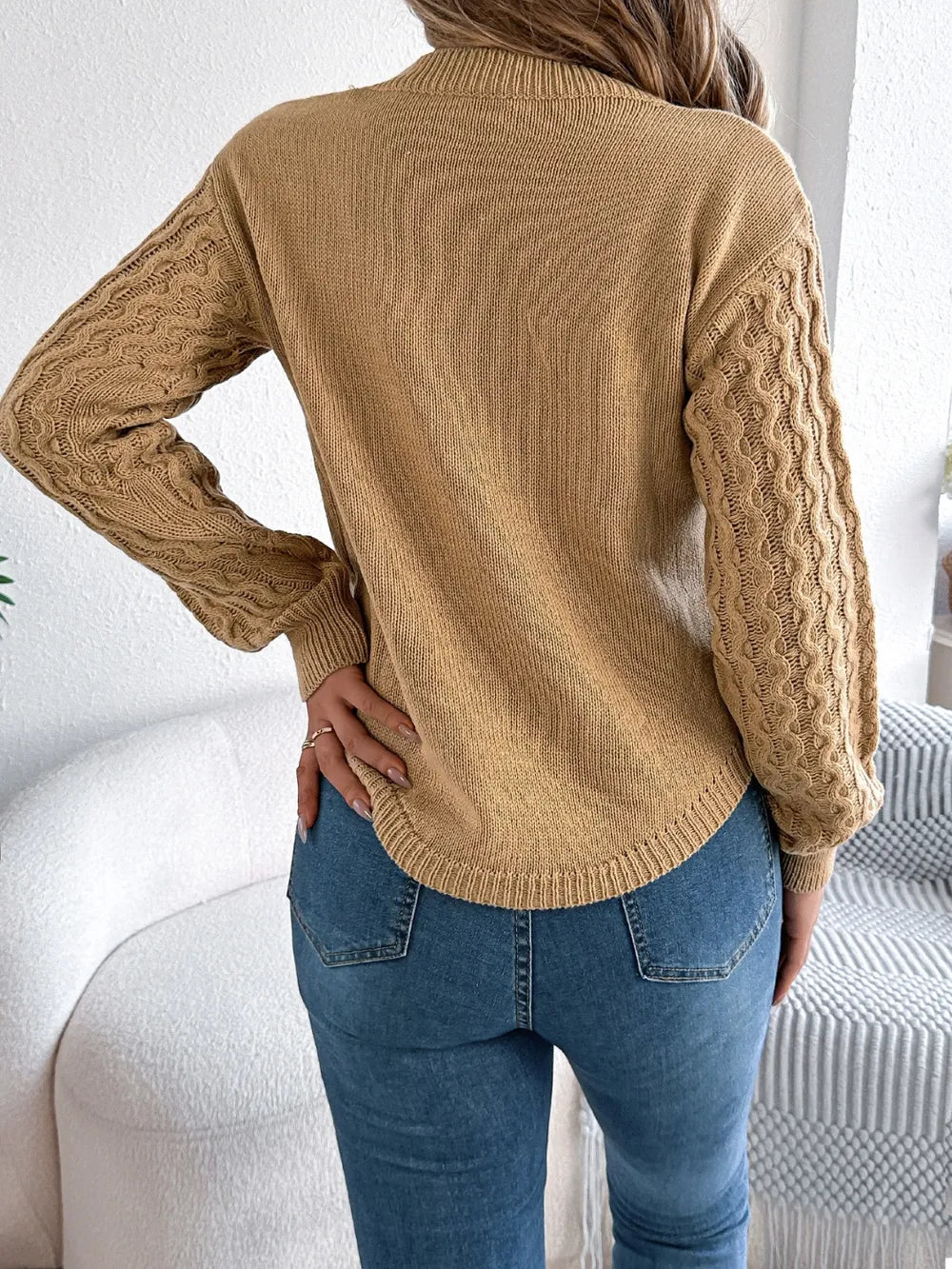 Back view of asymmetric hem round neck sweater