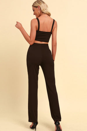 Back view highlighting chain accents and pants fit