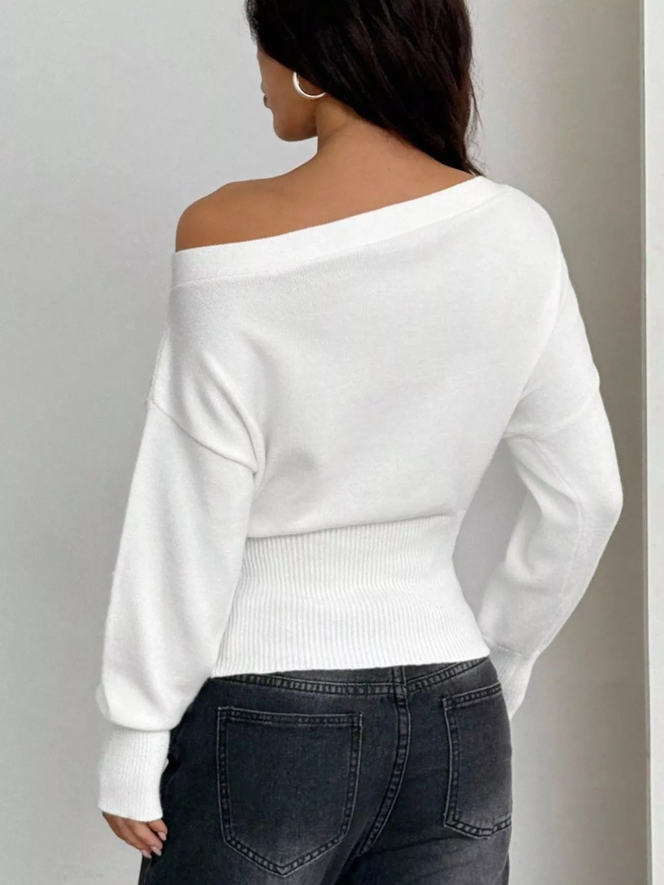 Back view of one shoulder cropped sweater