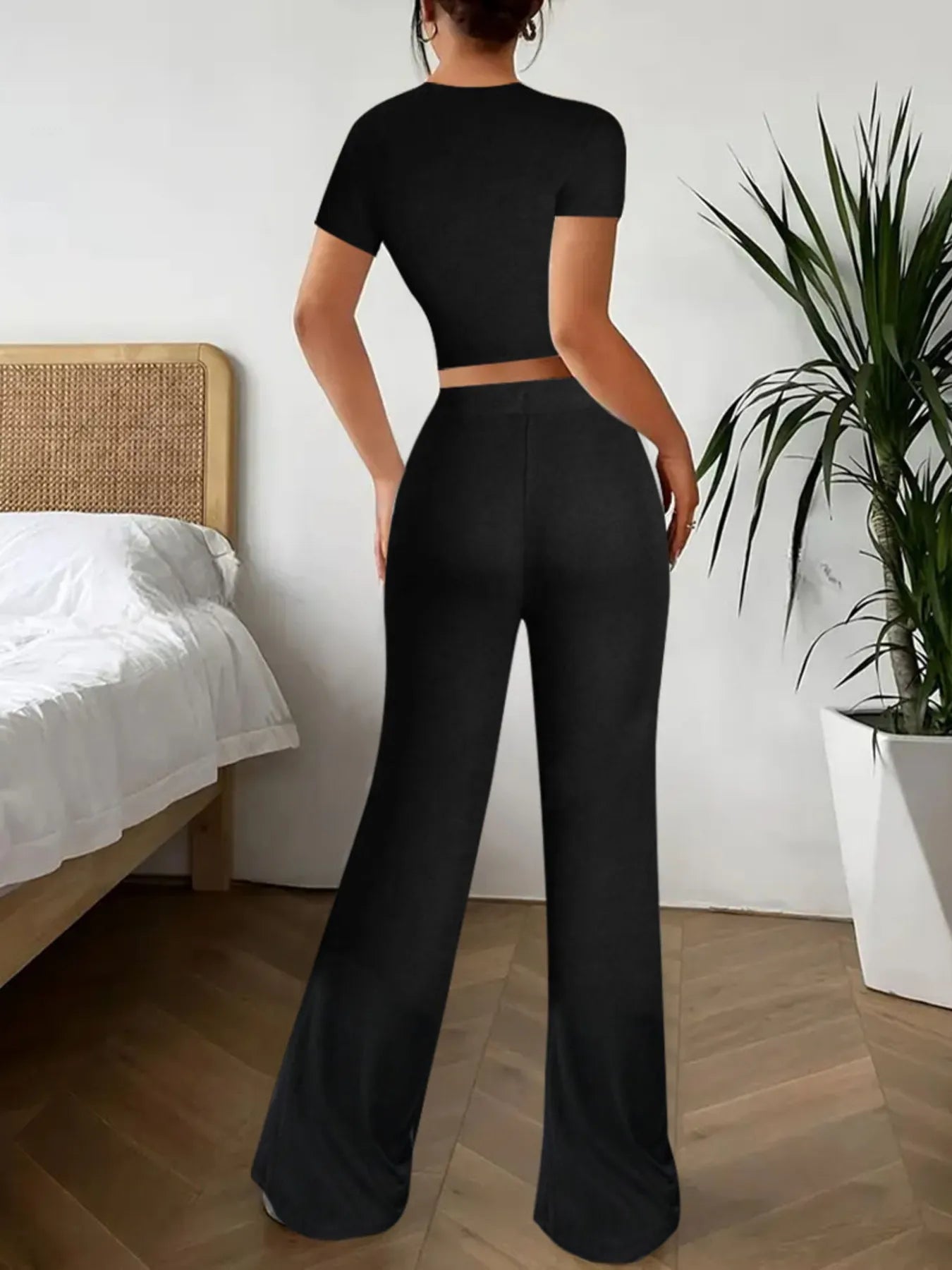 Back view showing crop top and wide leg pants silhouette