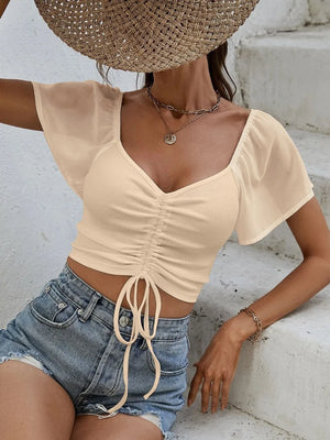 Front view of short sleeve crop top with drawstring waist
