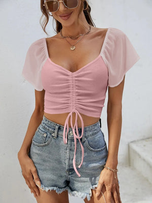 Front view of short sleeve crop top with drawstring waist