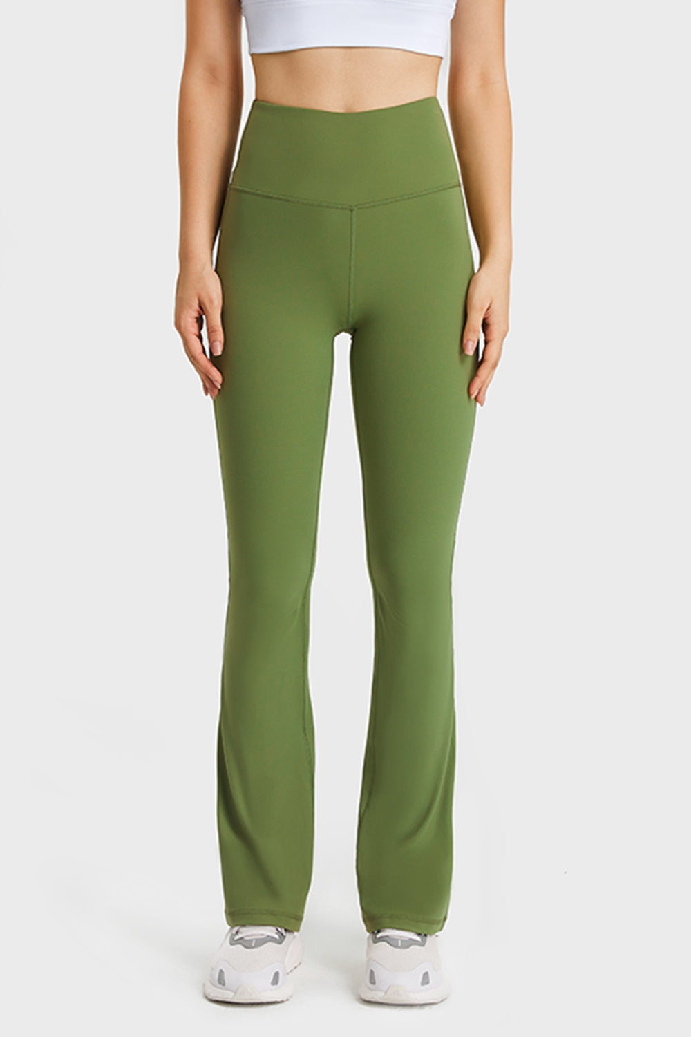 Front view showing Millennia yoga pants with elastic waistband and smooth flare at ankles