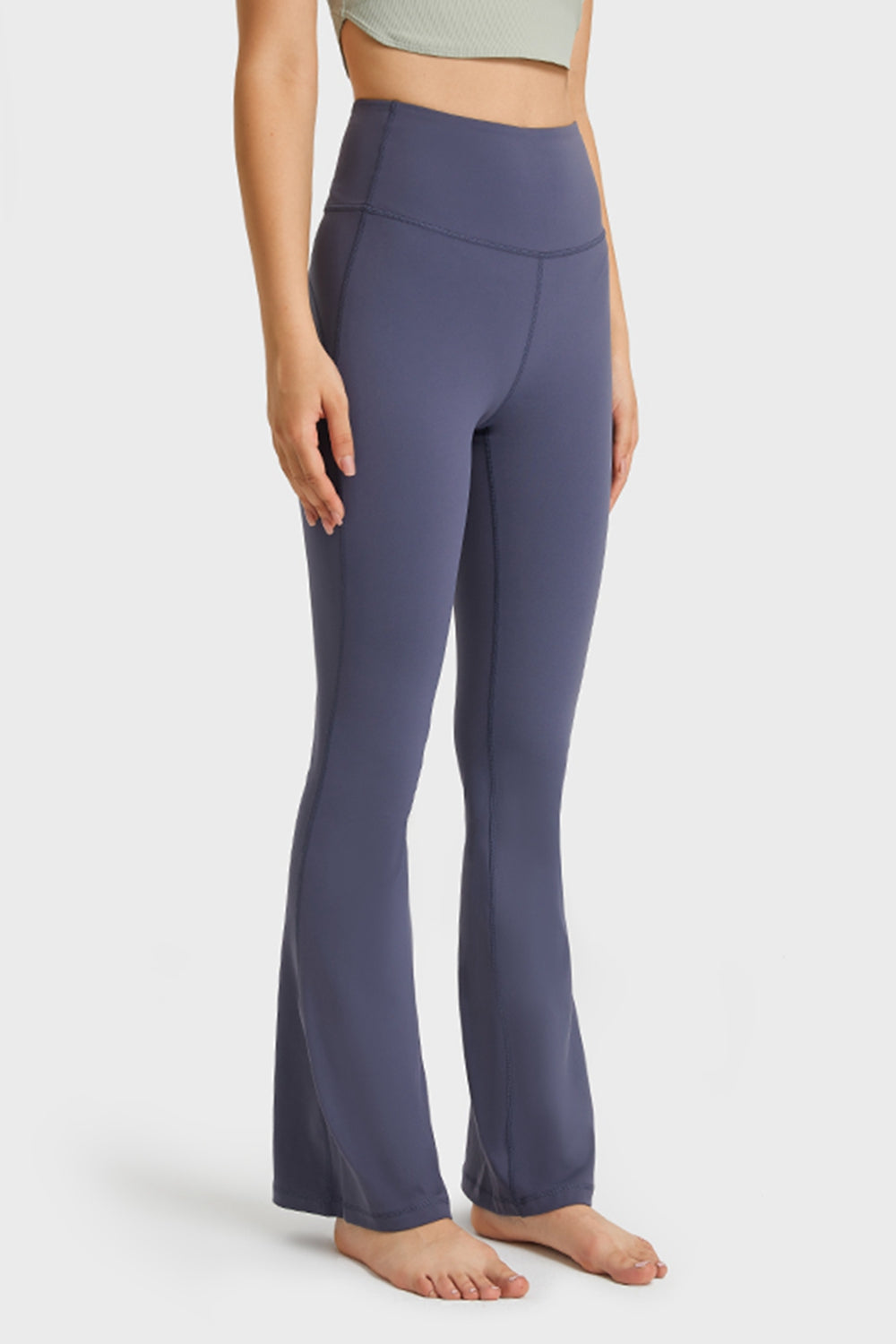Slightly tilted front view highlighting leg flare, waistband stretch, and fabric smoothness