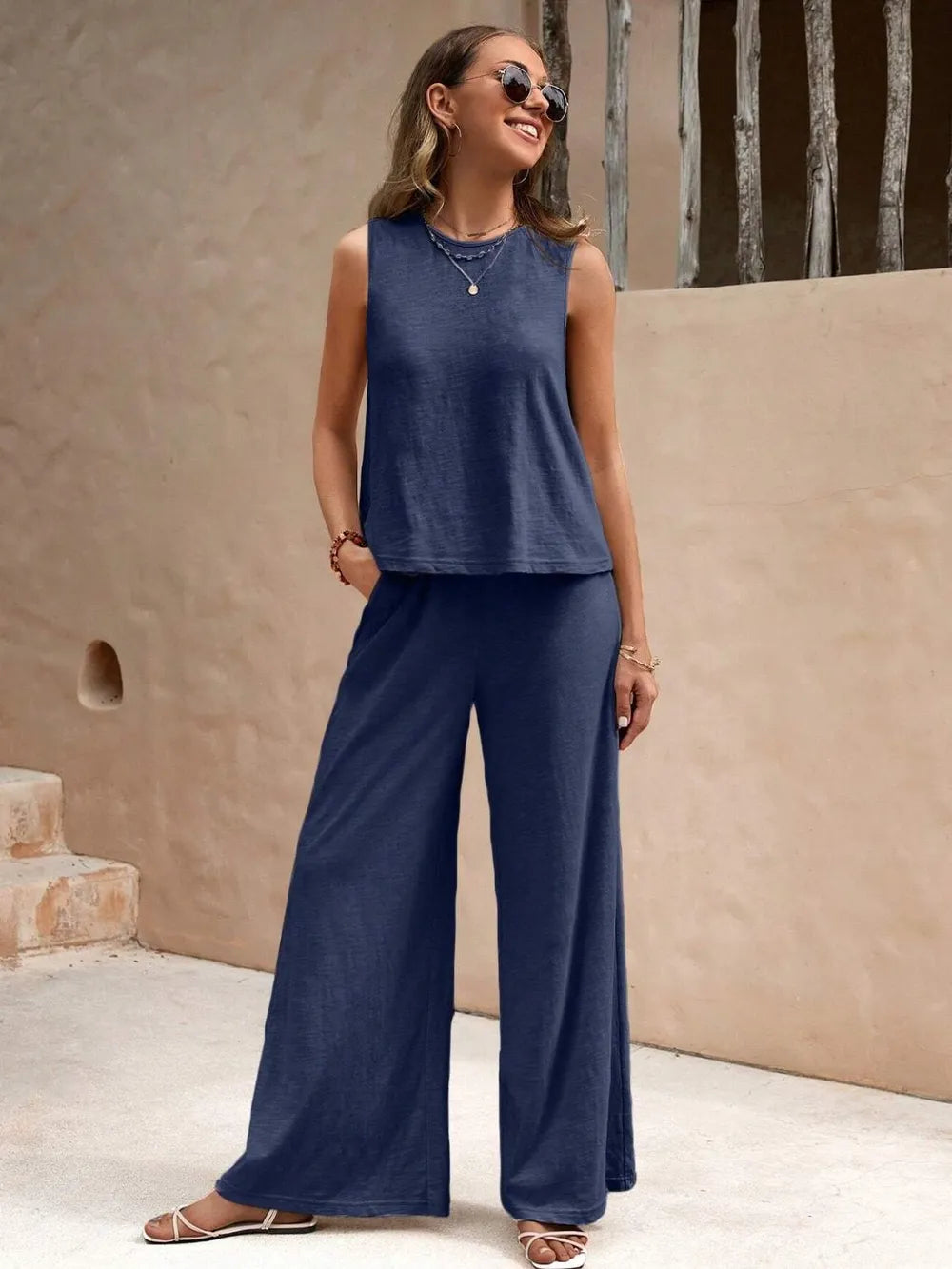 Model wearing round neck sleeveless top and wide leg pants set