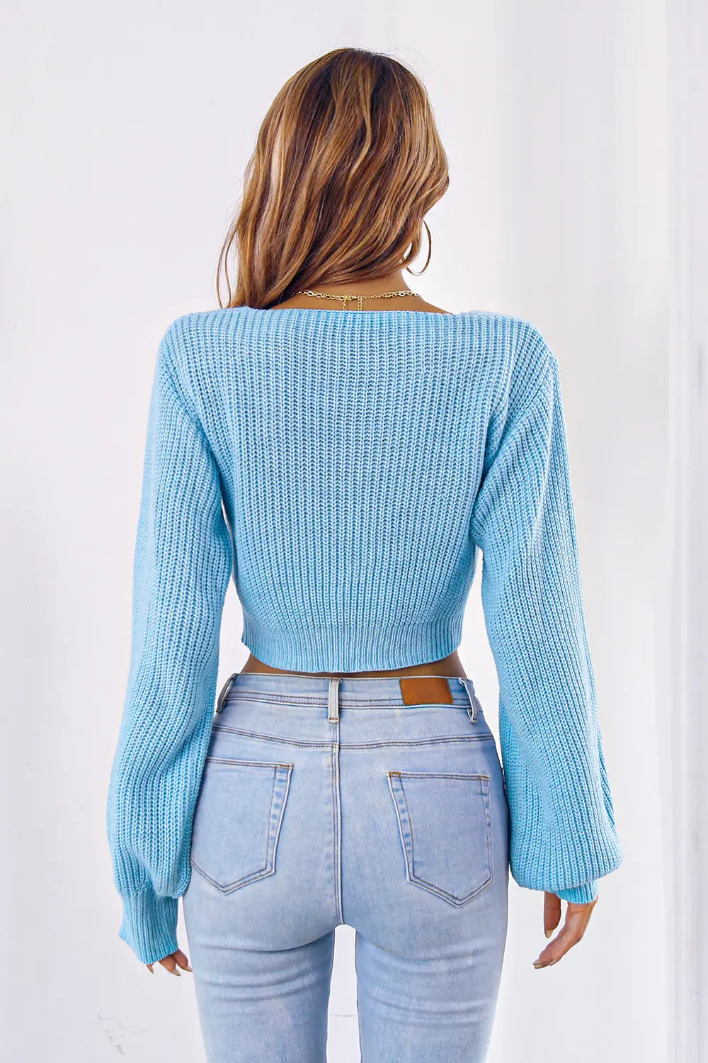 Back view of bow V-neck long sleeve cropped sweater
