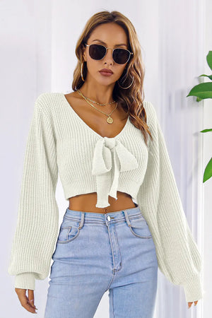 Front look of long sleeve cropped sweater with bow