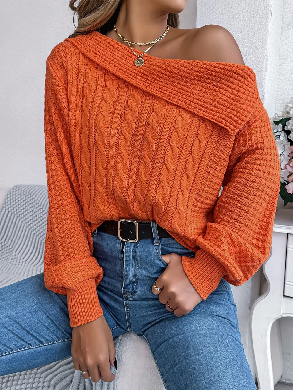 Front detail of one shoulder cable knit sweater soft fabric