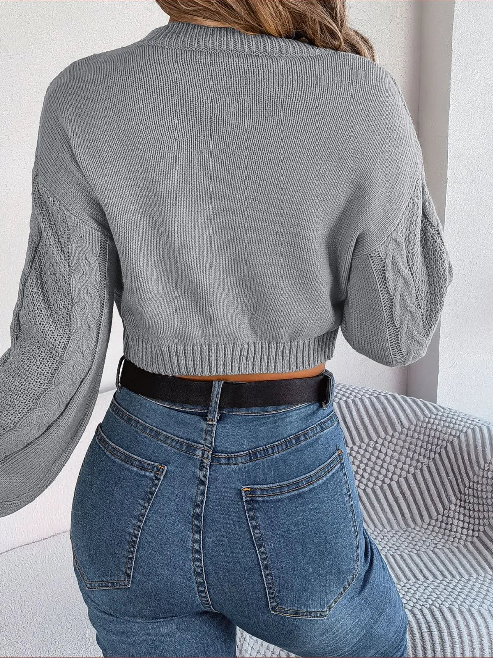 Back view of cable-knit round neck cropped sweater