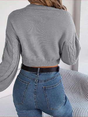 Back view of cable-knit round neck cropped sweater