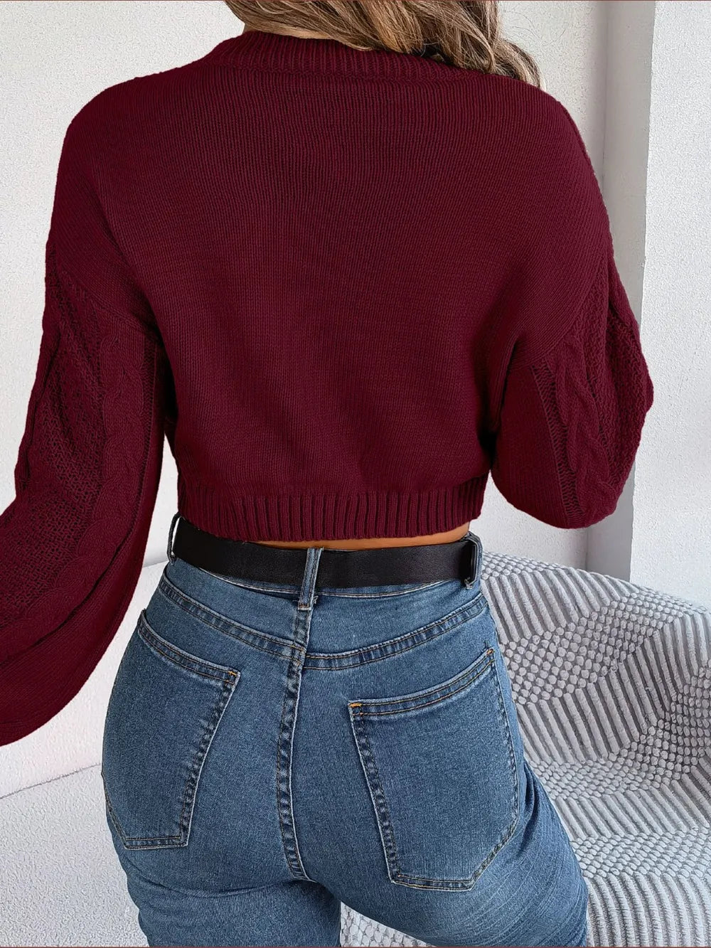 Rear angle view of cable-knit cropped sweater