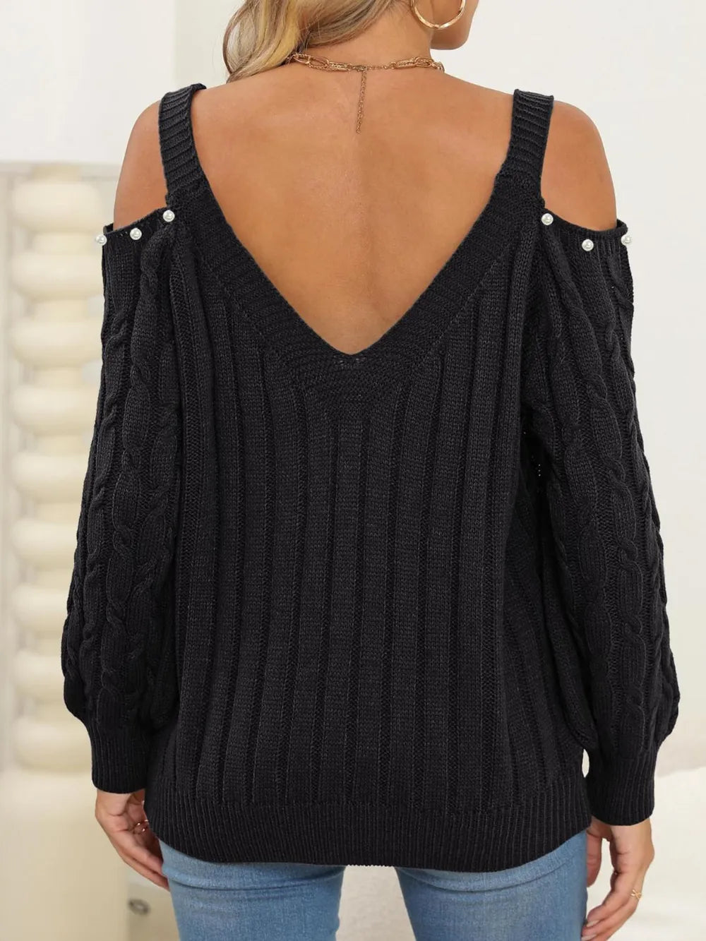 Back of Cable-Knit Cold Shoulder Sweater with cable knit pattern