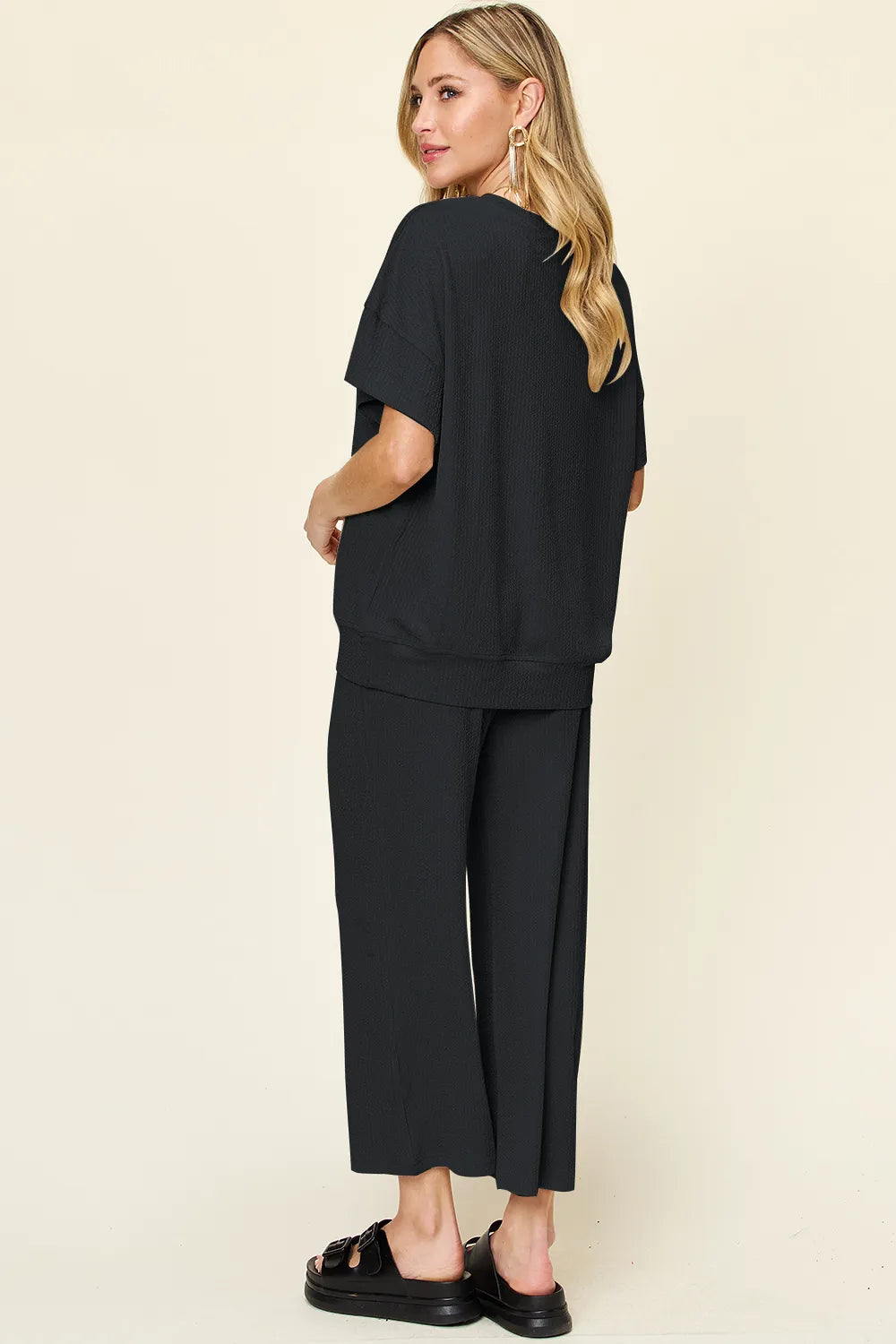 Back view of Double Take textured round neck t-shirt and pants