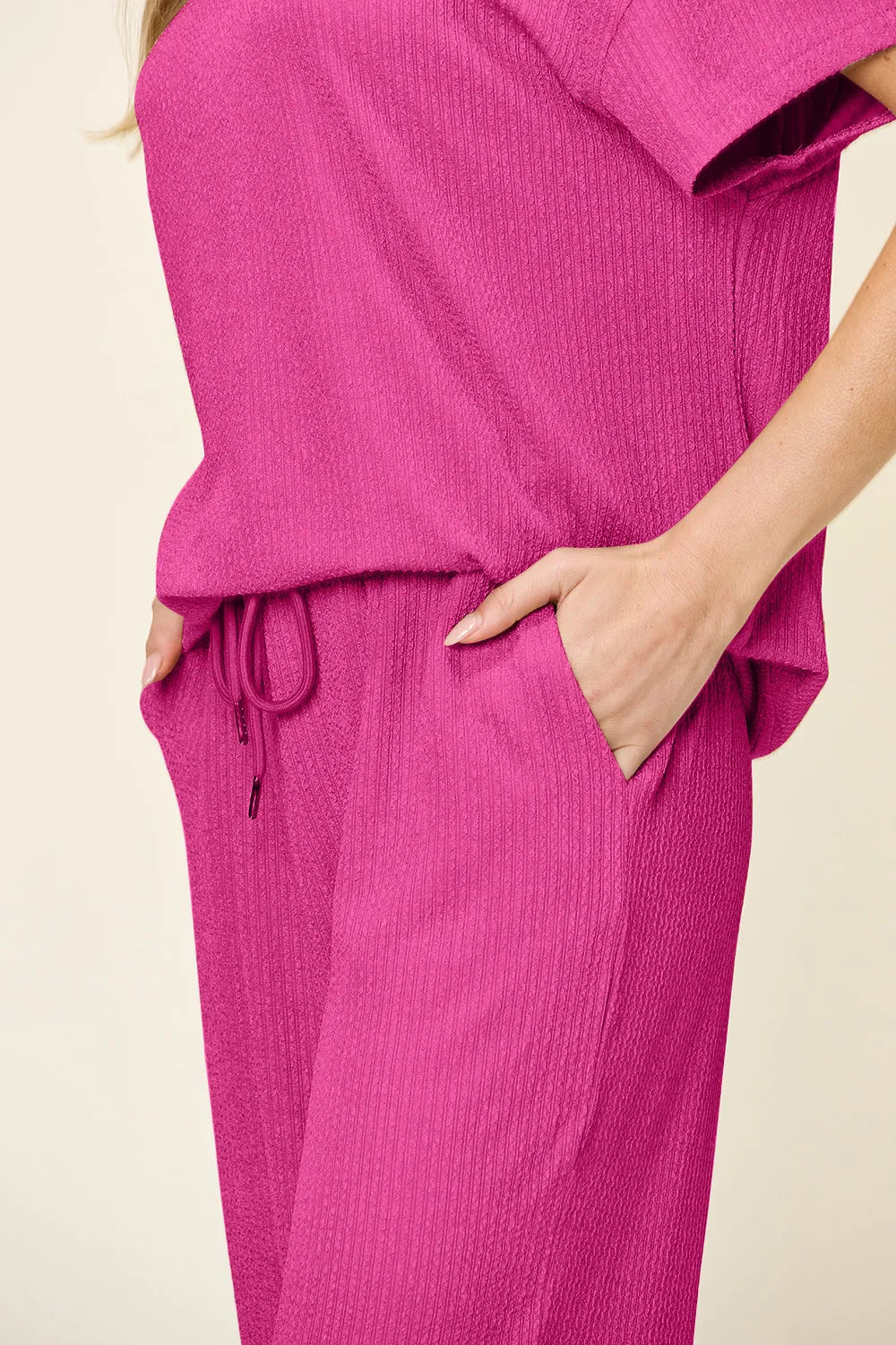 Side view of Double Take textured round neck t-shirt and pants set