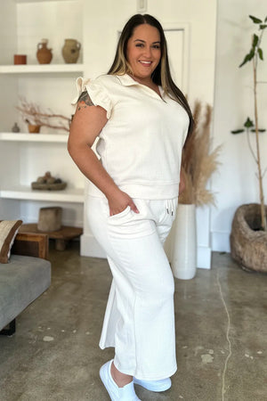 Side view of Double Take textured ruffle top and pants set