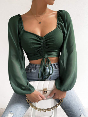 Front shot emphasizing the drawstring and fit of the top