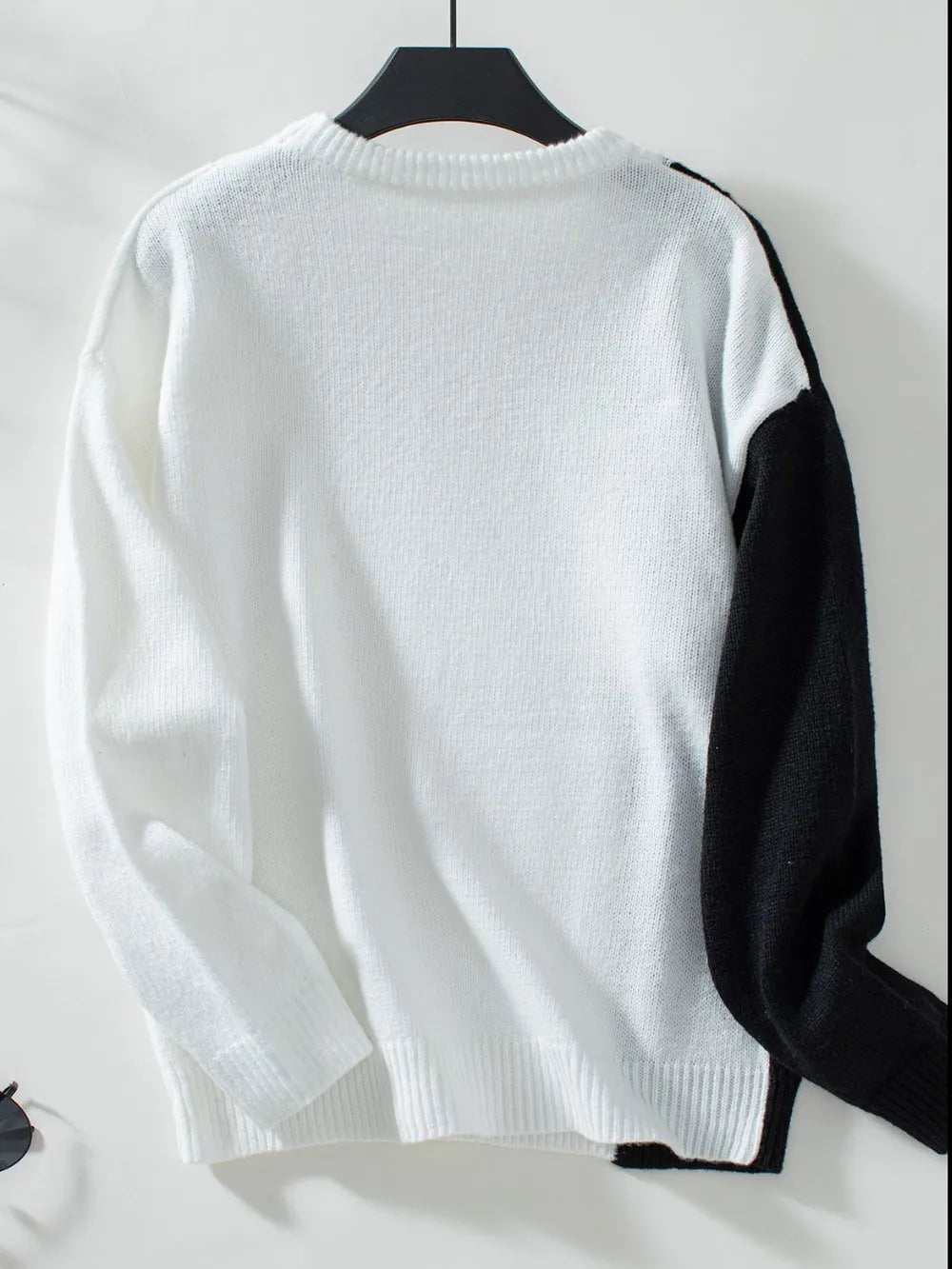 two tone long sleeve sweater on hanger retail display