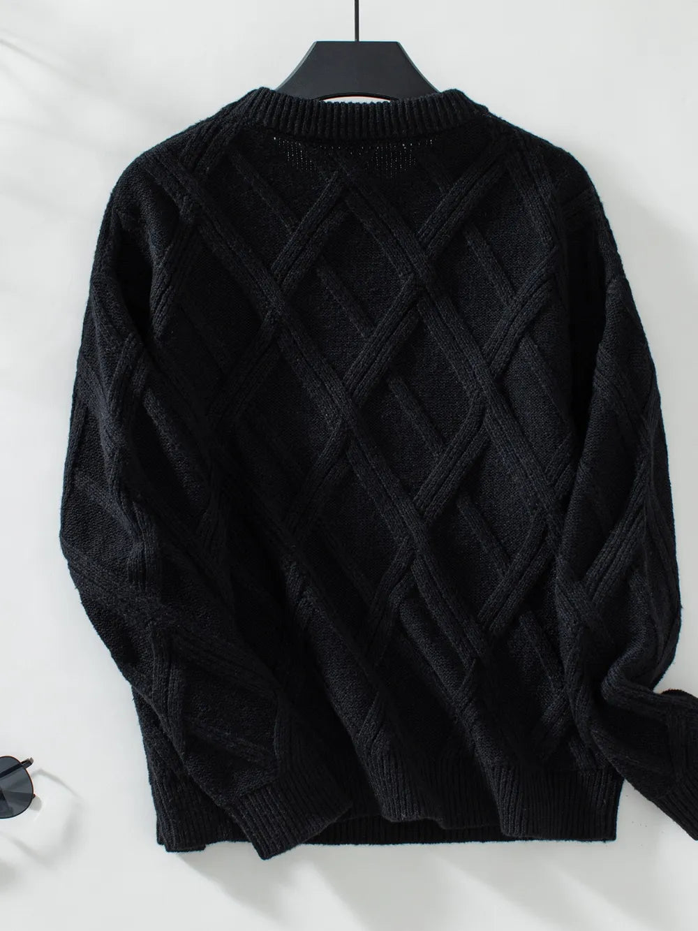 Women geometric sweater on hanger stylish winter clothing display