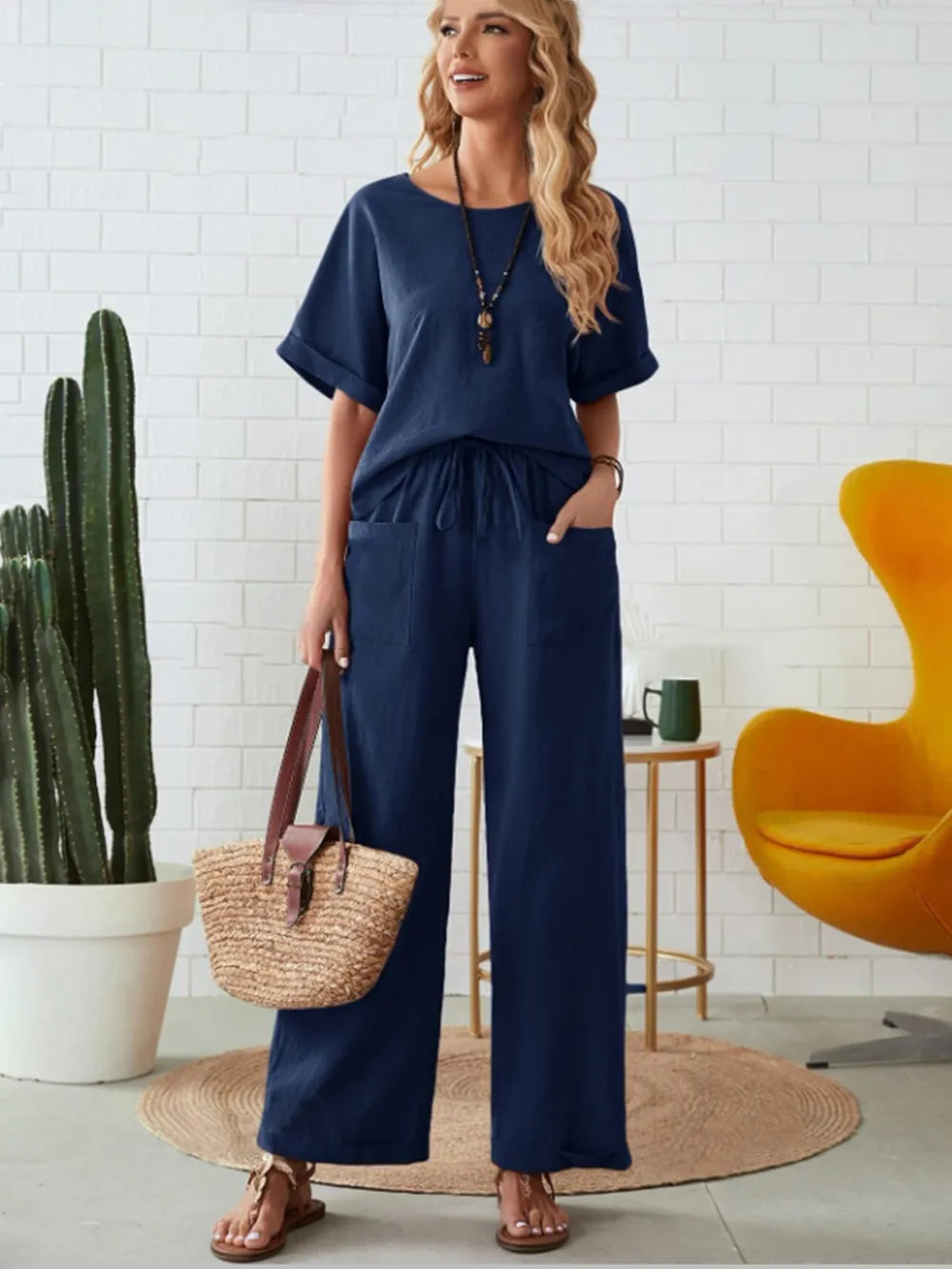 Front view of round neck half sleeve top and pocketed pants set
