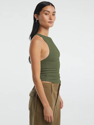 Side view highlighting the cropped fit and halter neck