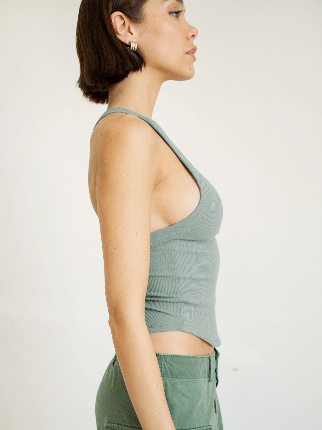 Side perspective highlighting cropped fit and neckline