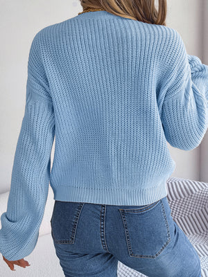 Cable-knit sweater back view with relaxed drop shoulder design