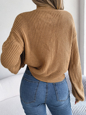 Back side of cable-knit sweater showing relaxed fit and stitching detail
