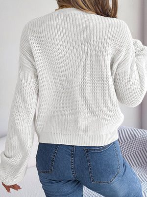 Back view of cable knit sweater highlighting soft fabric and design