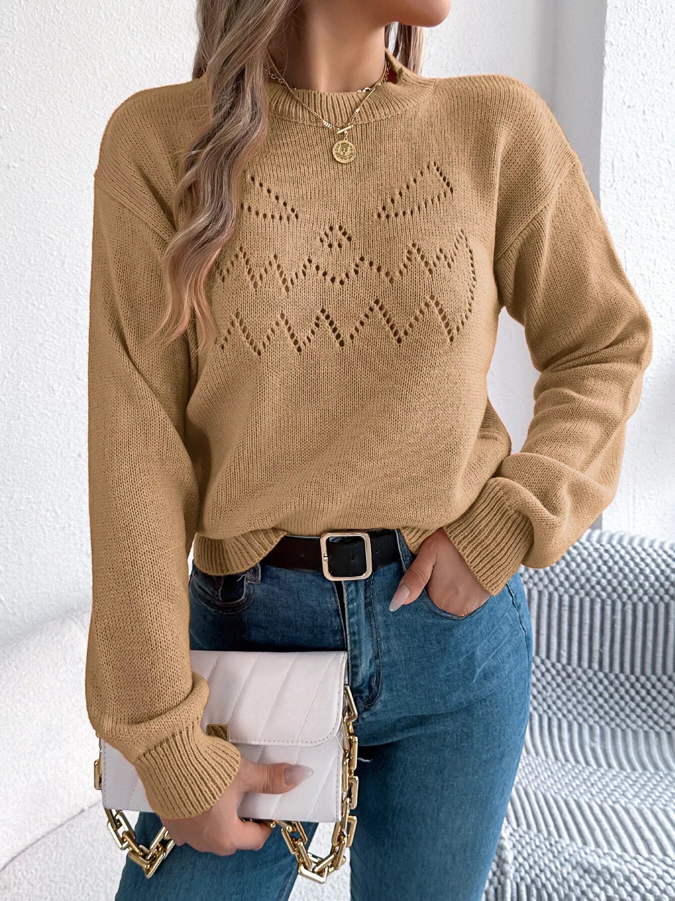 Front detail of round neck openwork sweater soft knit fabric