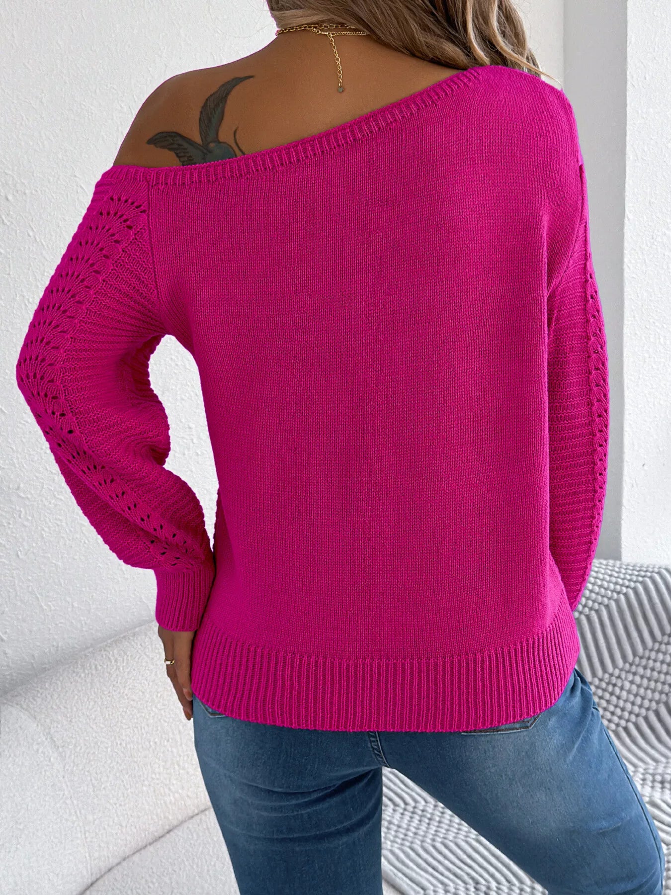 Rear view of openwork one shoulder long sleeve sweater