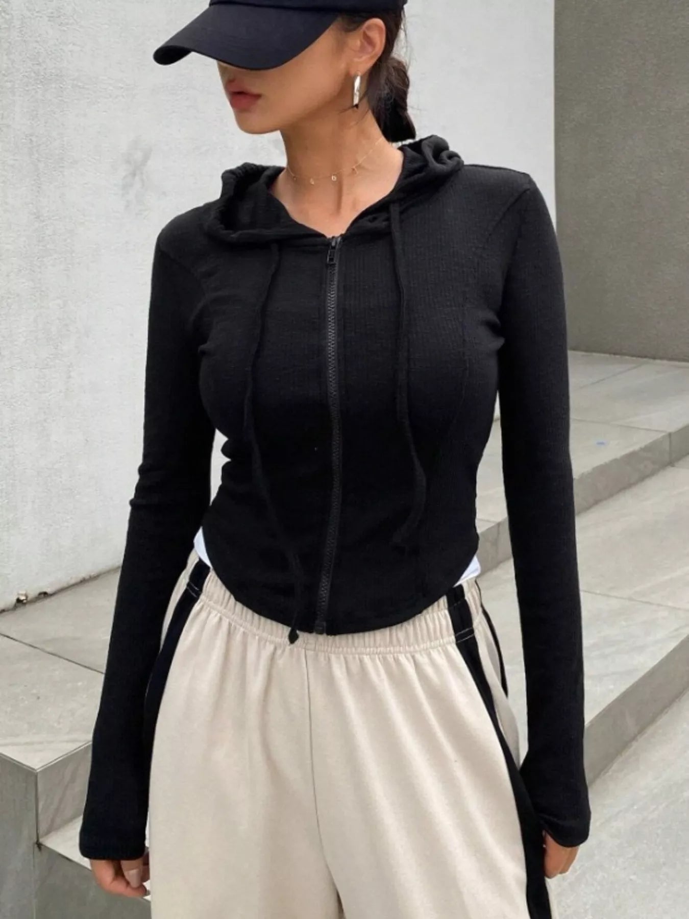 Close-up of ribbed knit cropped zip-up jacket