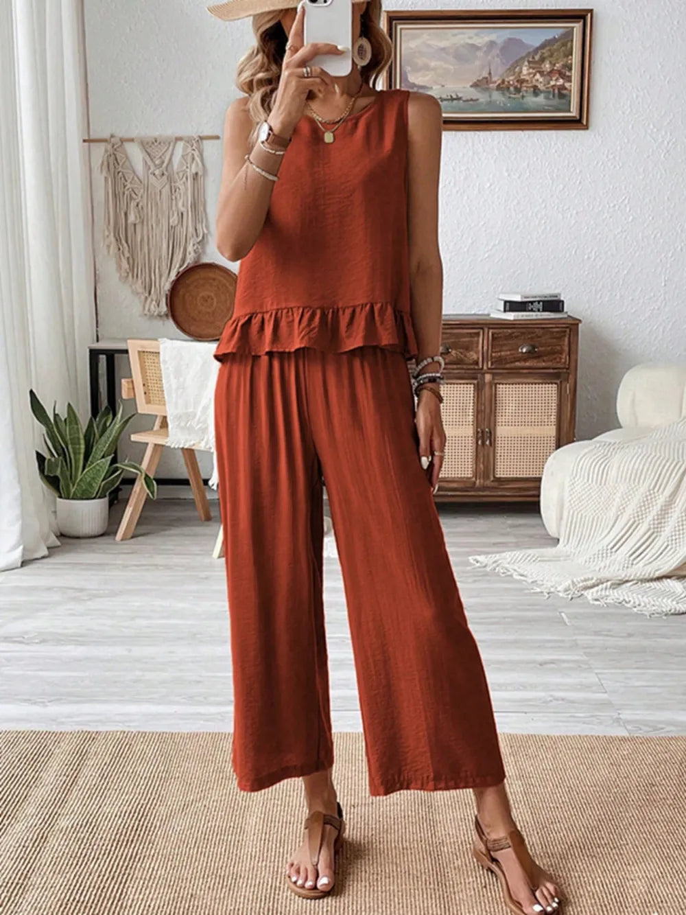 Model wearing ruffled round neck top and wide leg pants front view