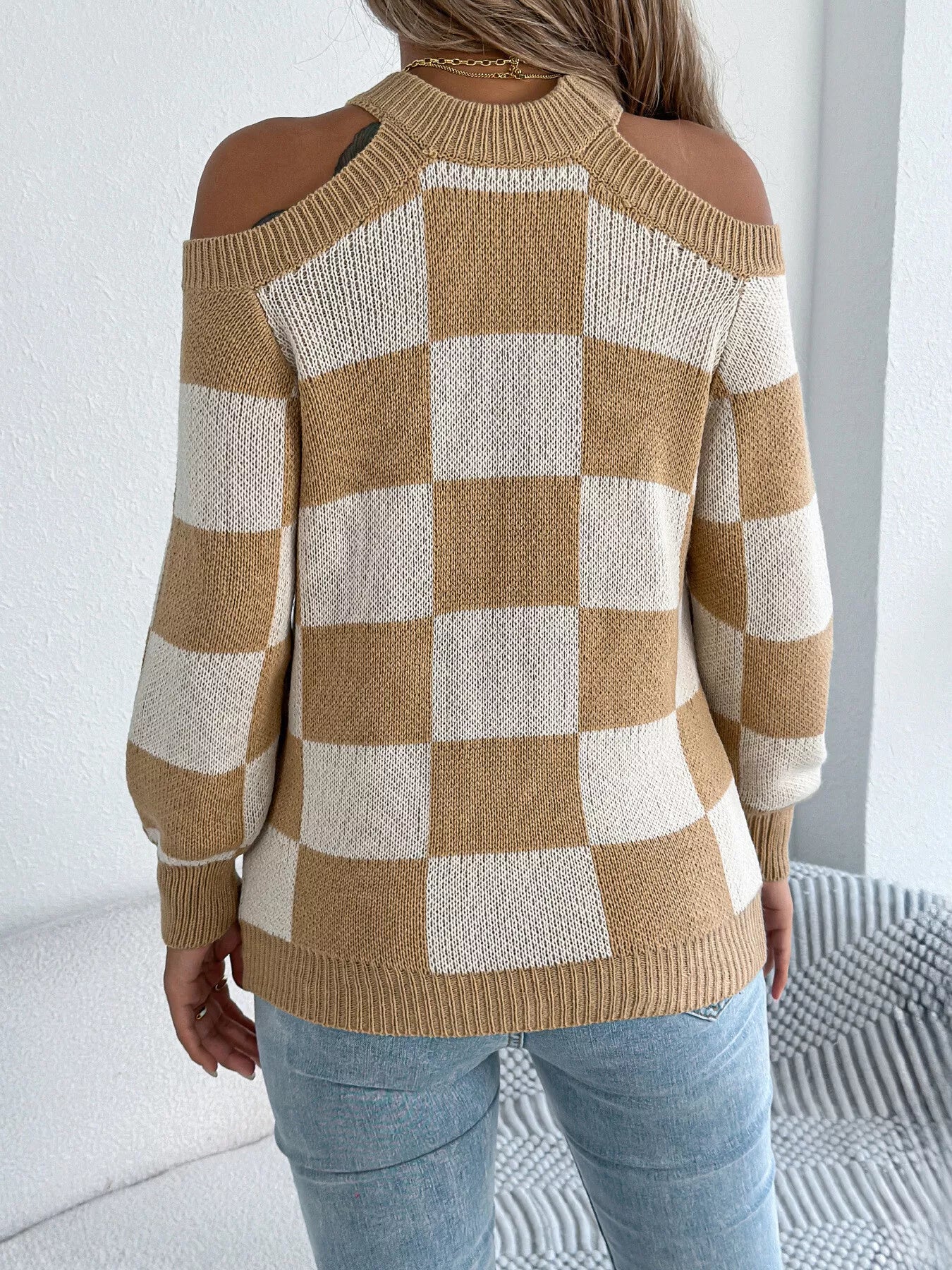 Back profile of cold shoulder checkered sweater