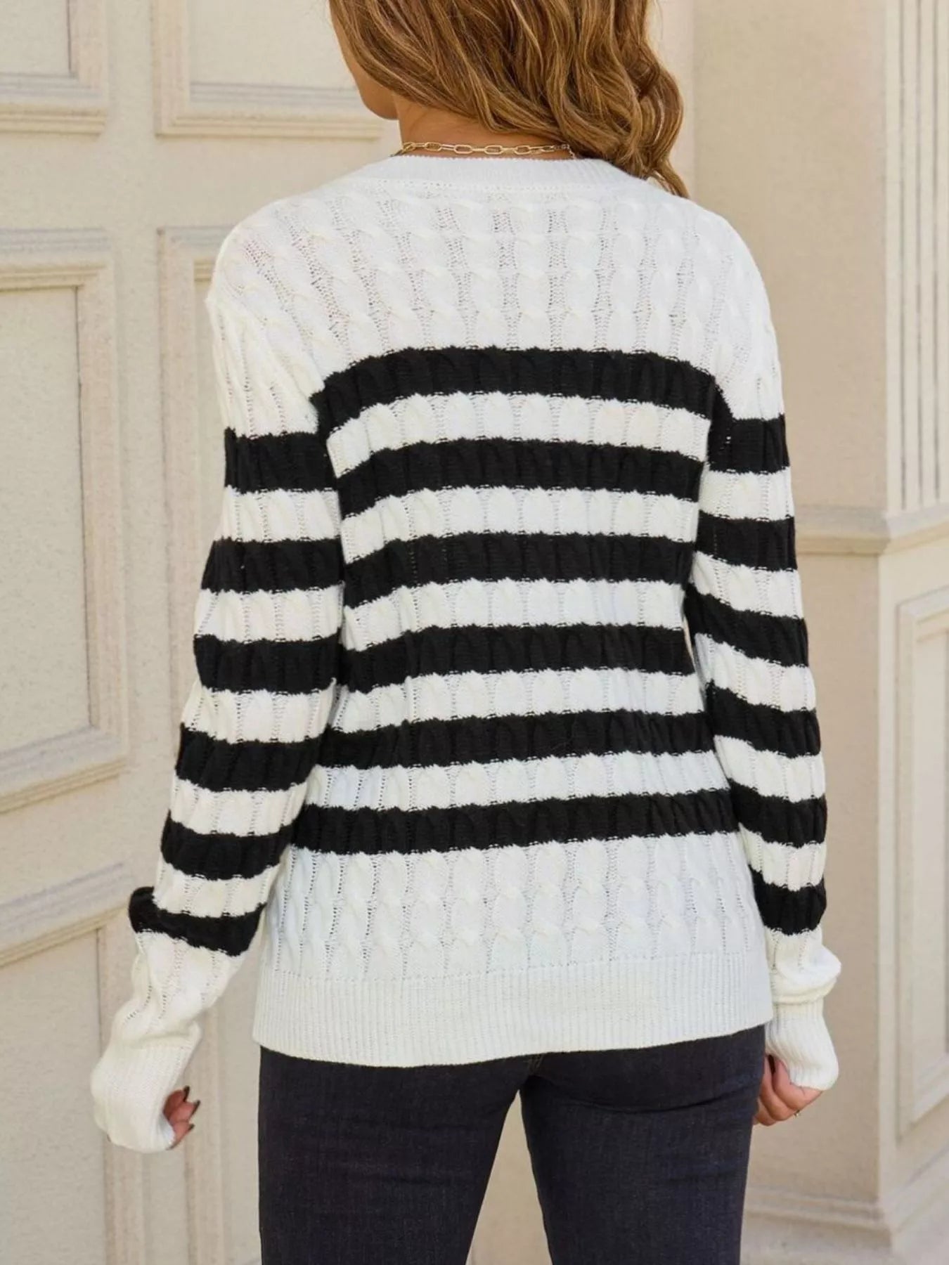 back view of striped cable knit round neck sweater